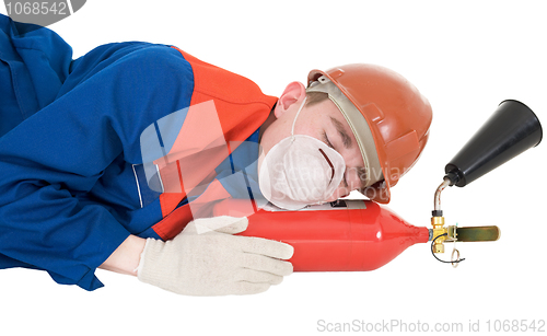 Image of Sleeping laborer with fire extinguisheron 