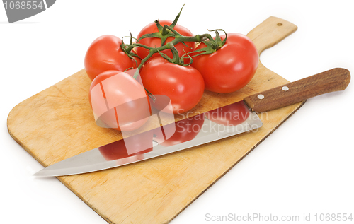 Image of Knife and branch tomatoes