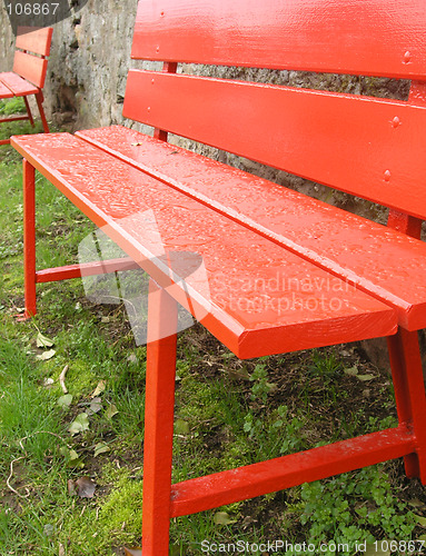 Image of Red benches in green grass