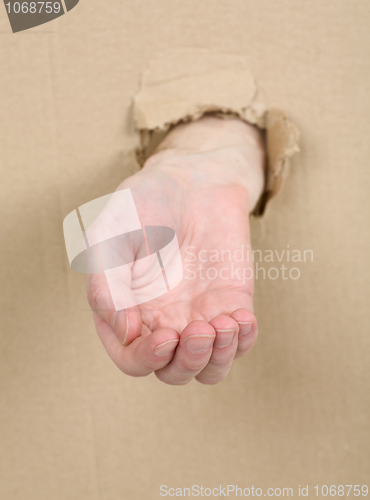 Image of Male hand through in cardboard