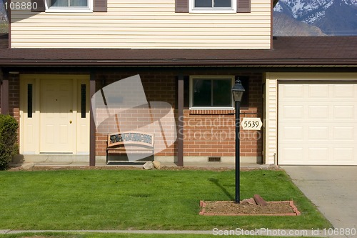 Image of Front of a House with Mountains on the Background