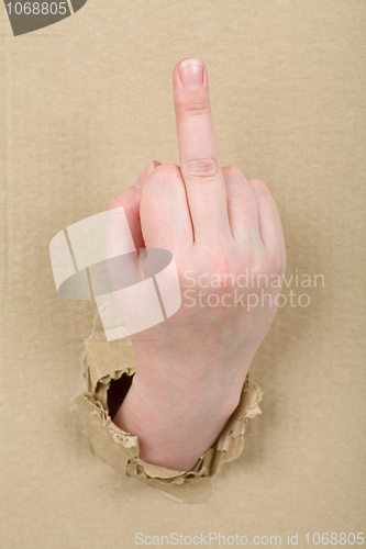 Image of Gesture female hand through cardboard