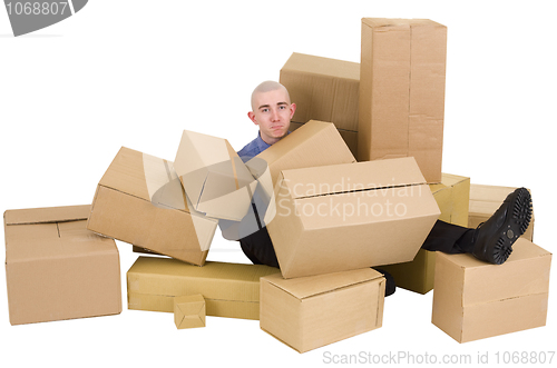 Image of The man is heap up by boxes