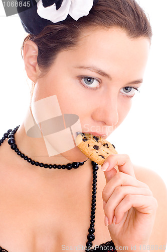 Image of woman in corset and little hat eating cookie