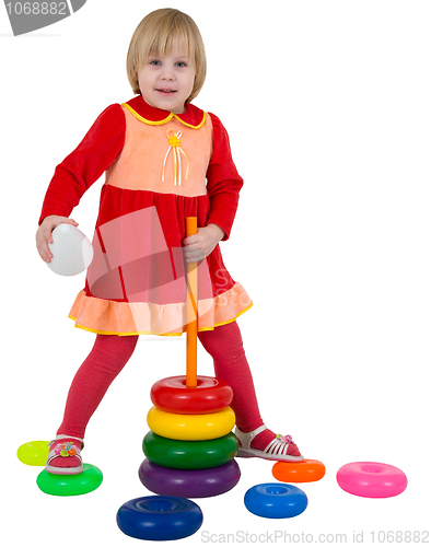 Image of Small girl and toy plastic pyramid