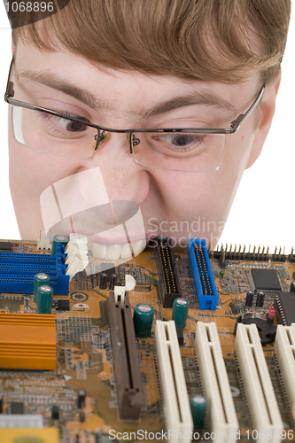 Image of Guy bites an old circuit board