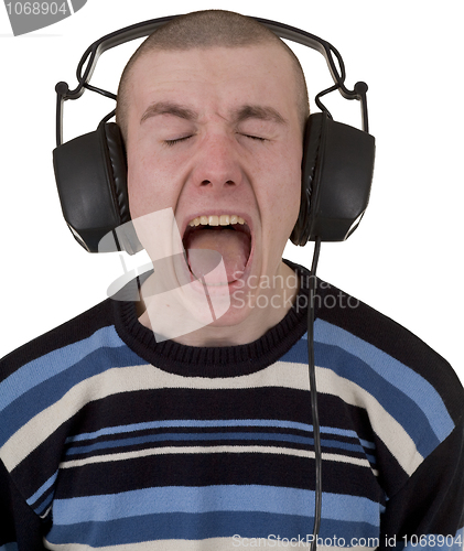 Image of Young man in earphones loudly sings