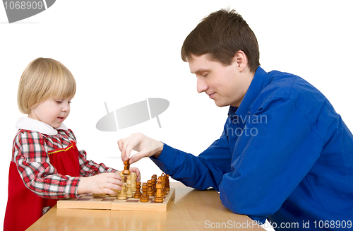 Image of Man and child play chess