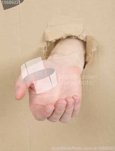 Image of Male hand through in cardboard