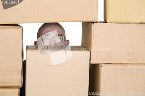 Image of Man looking through pile of cardboard boxes