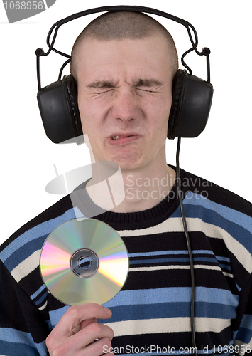 Image of The young guy with ear-phones and a compact disk