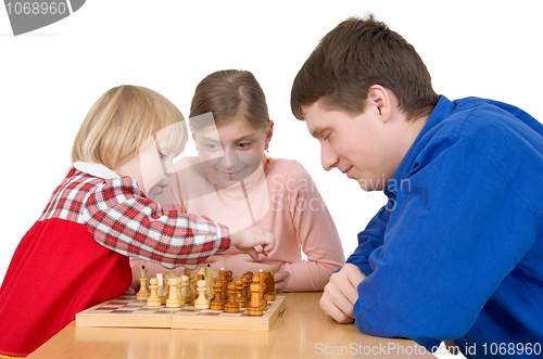 Image of Man and child play chess