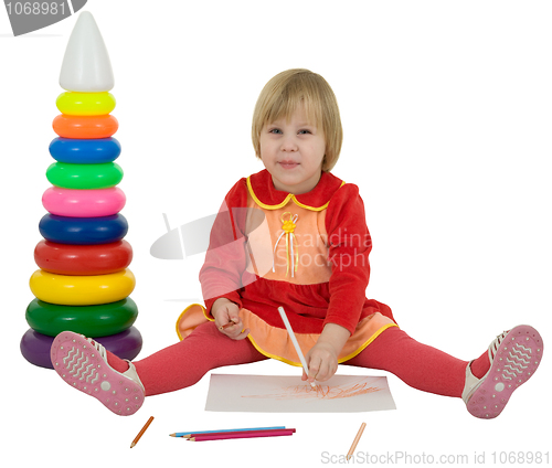 Image of Little girl and crayons and toy pyramid
