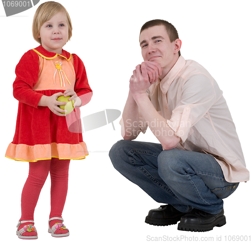 Image of Little girl with green apple and young man