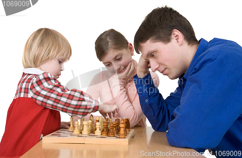 Image of Man and child play chess