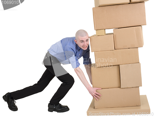 Image of Man push pile cardboard boxes