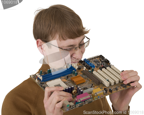 Image of Young man bite motherboard