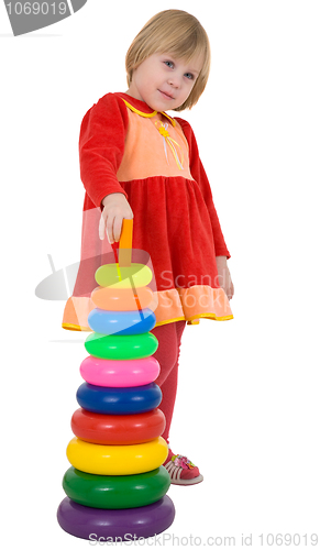 Image of Little girl and plastic toy pyramid