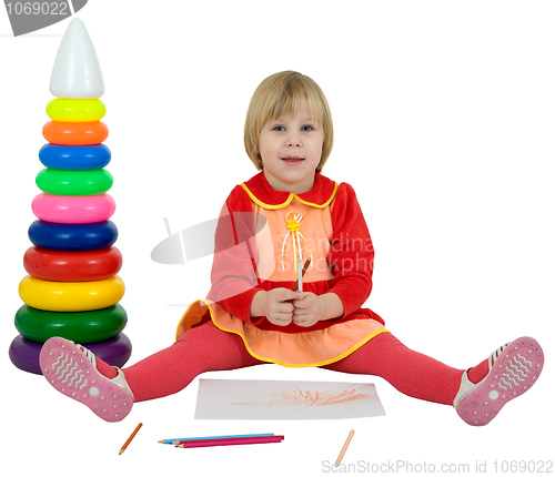 Image of Little girl and toy pyramid and crayons