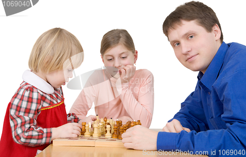 Image of Man and childs play to chess