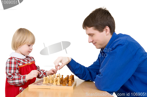 Image of Man and girl play chess