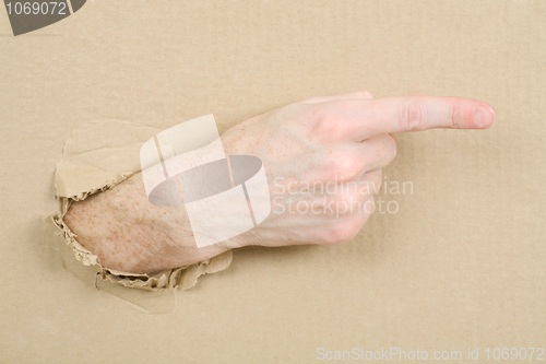 Image of Gesture male hand through cardboard