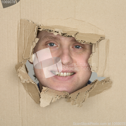 Image of Male face in hole carton