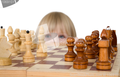 Image of Little girl looking chess