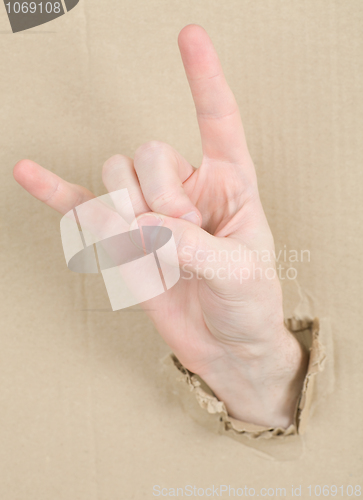 Image of Gesture male hand through cardboard