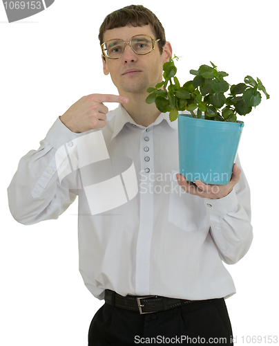 Image of Man in spectacles showing on window plant