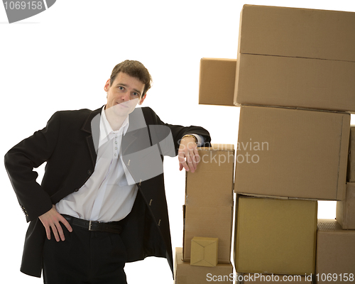 Image of Man lean one's elbows on cardboard boxes