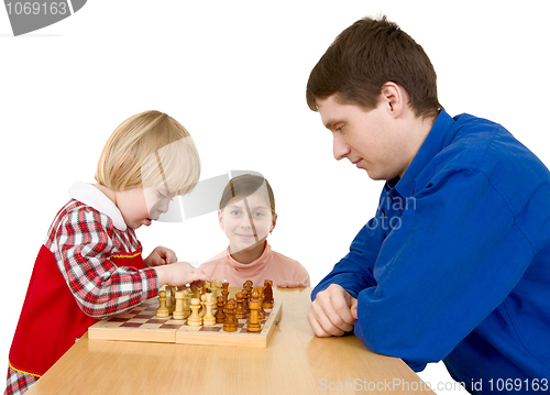 Image of Man and childs play chess