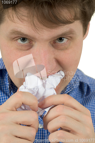 Image of The man a chewing sheet of paper