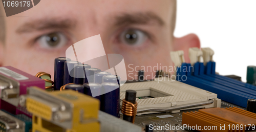 Image of Man examines an electronic circuit