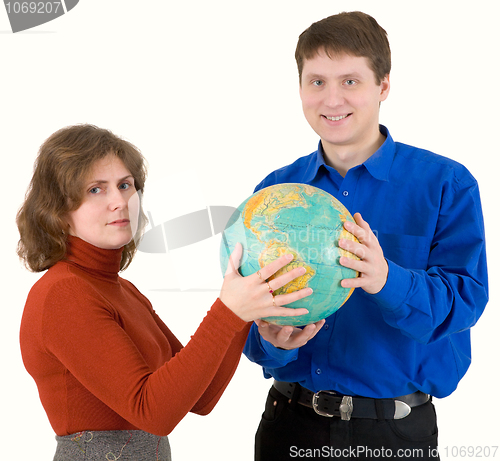 Image of Man and woman hold globe