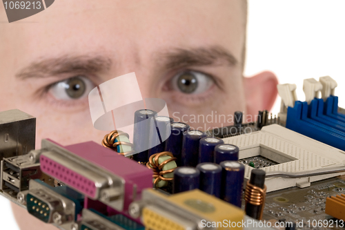 Image of Man examines an electronic circuit