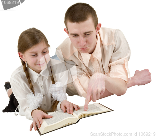 Image of Young man and girl reading book