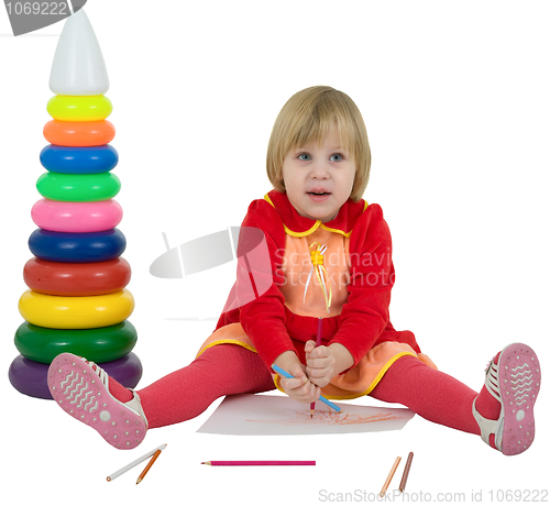 Image of Little girl and toy pyramid and crayons