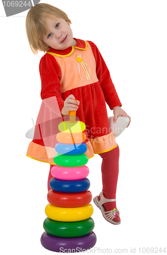 Image of Little girl and toy plastic pyramid