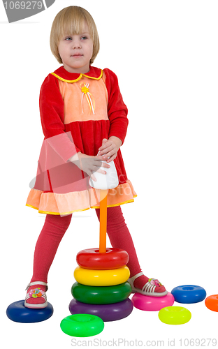 Image of Little girl and toy plastic pyramid