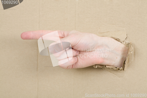 Image of Gesture male hand through cardboard