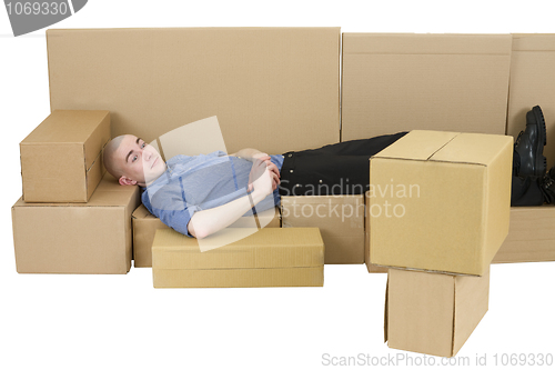 Image of Man with carton TVset and sofa