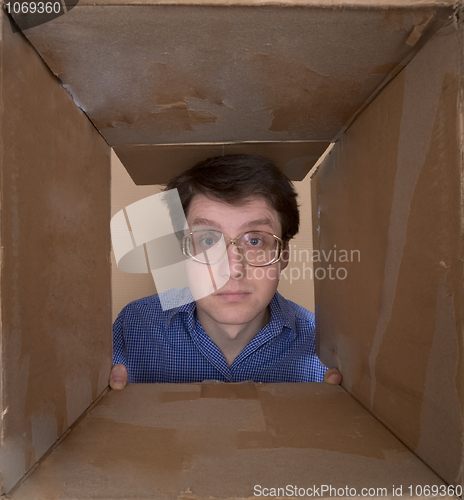 Image of Man portrait inside carton box