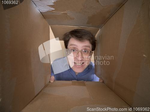 Image of Man portrait inside carton box