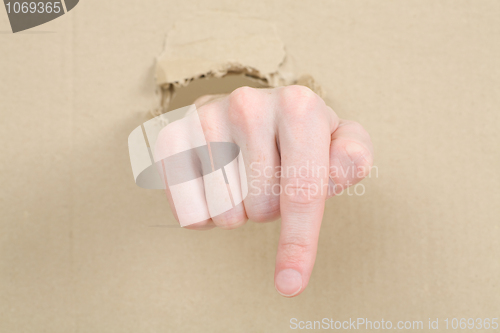 Image of Gesture male hand through cardboard