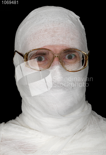 Image of Guy rolled up by bandage in spectacles