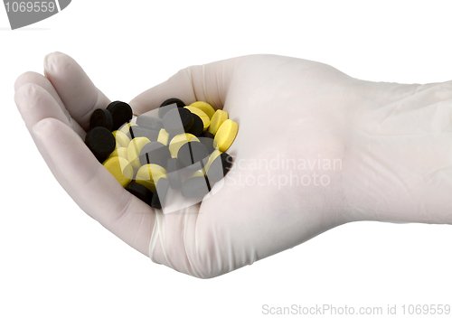 Image of Tablets on hand in glove