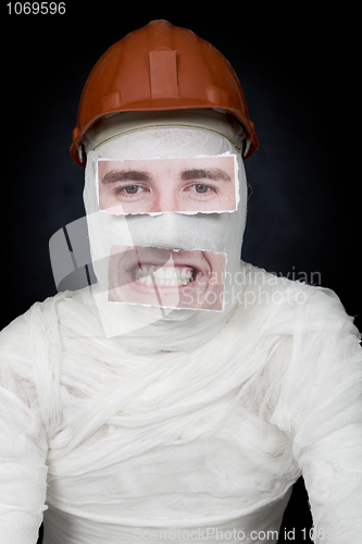 Image of Guy in bandage with the helmet and false face