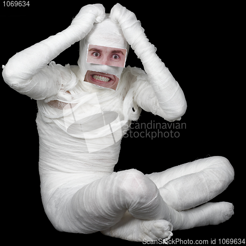 Image of Man in bandage with false eyes and mouth