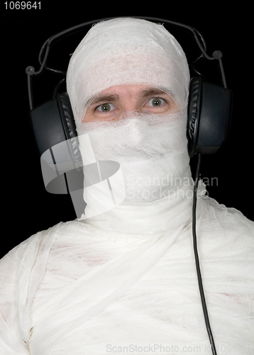 Image of Man in bandage with ear-phones